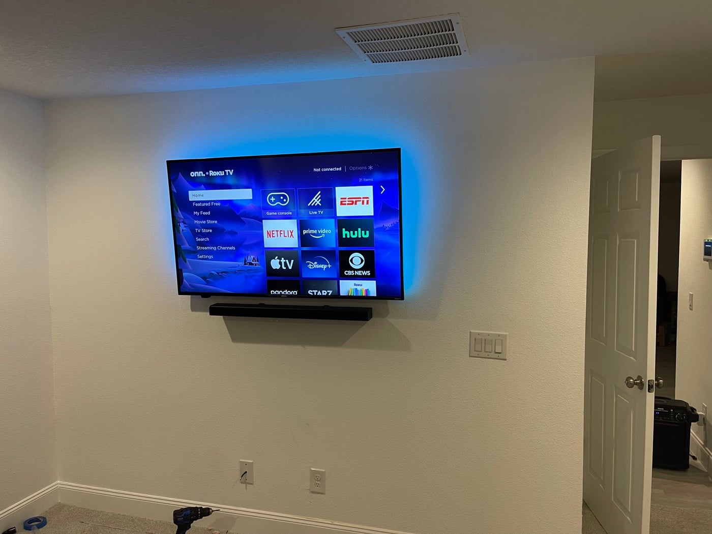 TV and soundbar mounted with LED backlighting